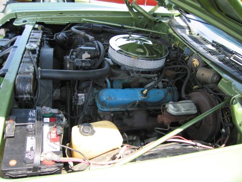 2001 Ford Crown Victoria - Close-up view of a car's engine bay, showing the engine components and battery.