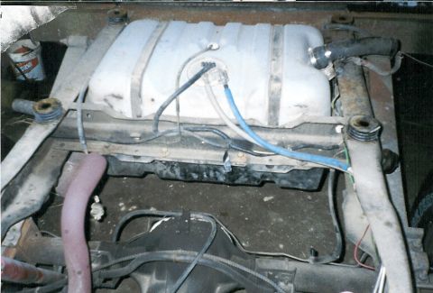 1983 Ford Bronco - Close-up view of the undercarriage of a vehicle, focusing on the fuel tank and associated parts.