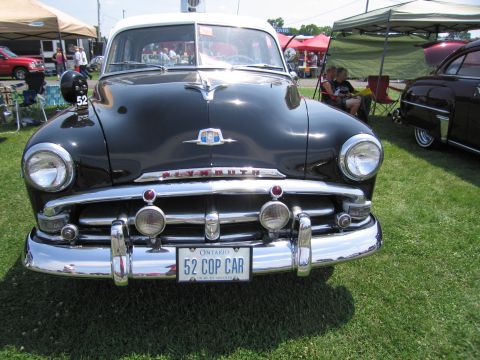 2001 Ford Crown Victoria - This 1952 Plymouth Cranbrook police car is displayed at an outdoor event.