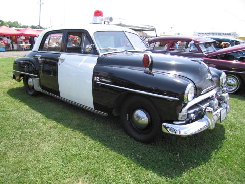 2001 Ford Crown Victoria - This vintage police car, marked with '52', is on display at an outdoor event.