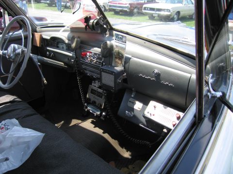 2001 Ford Crown Victoria - Dashboard of a vintage police car equipped with radio and communication devices.