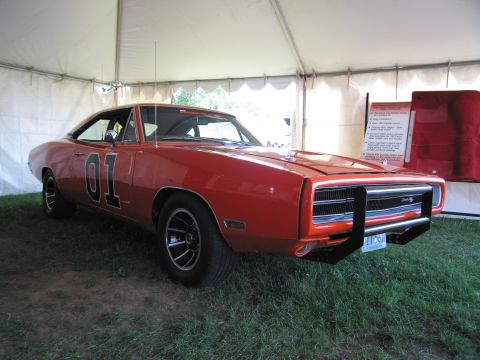 2001 Ford Crown Victoria - This iconic car, known as the General Lee, is displayed under a tent with informational signage nearby.