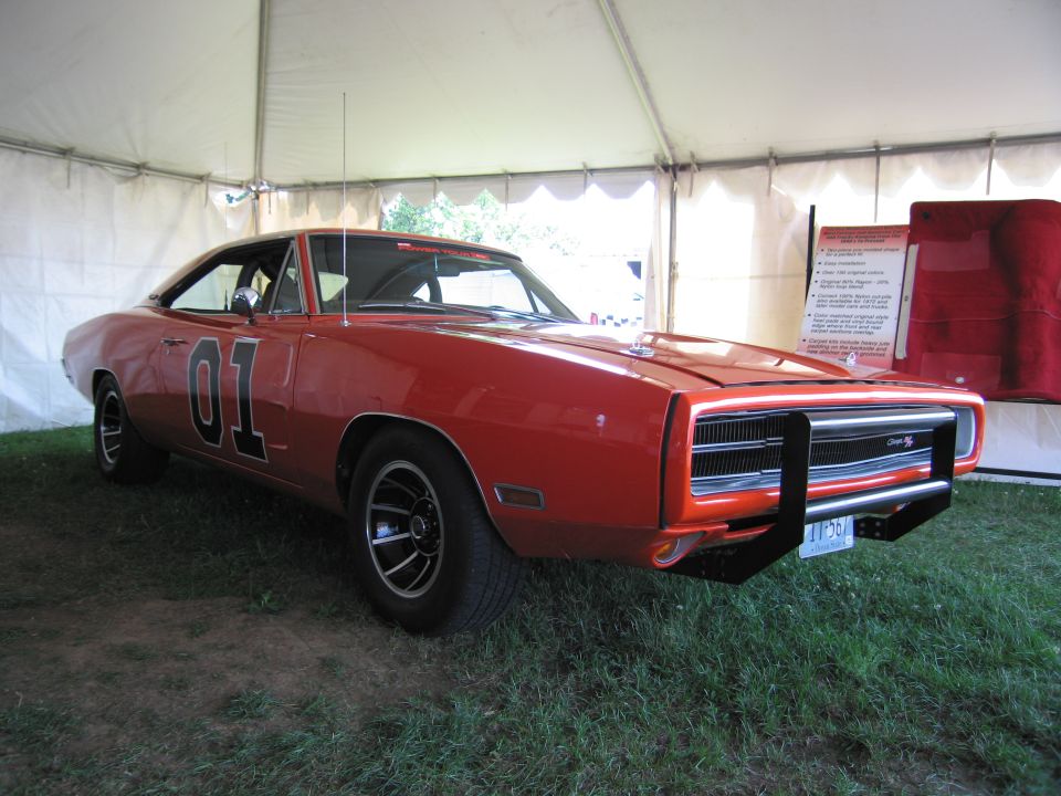 Orange 1969 Dodge Charger with "01" on doors, under a tent