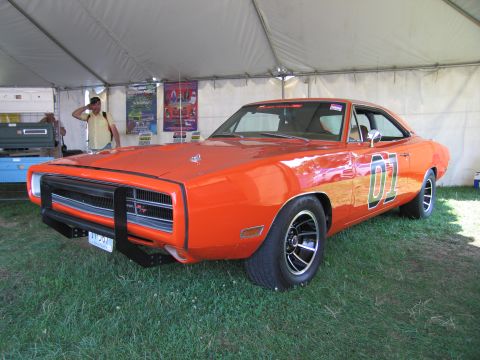 2001 Ford Crown Victoria - This orange muscle car, identified as a 1969 Dodge Charger, is equipped with a distinctive black bull bar and prominent "01" graphics on it…