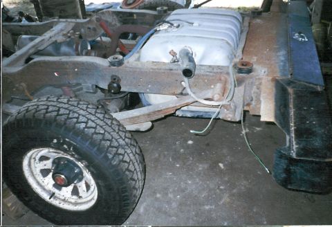 1983 Ford Bronco - Close-up of a vehicle's undercarriage, focusing on the fuel tank and frame components.