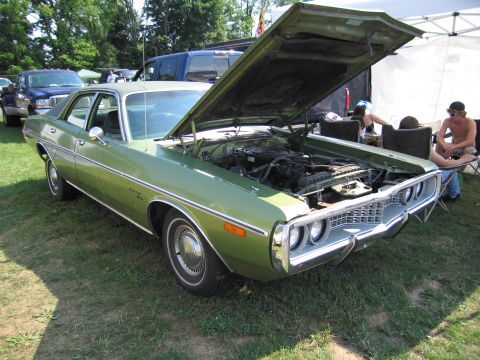 2001 Ford Crown Victoria - This green 1973 Dodge Coronet sedan is displayed with its hood open, revealing the engine compartment.
