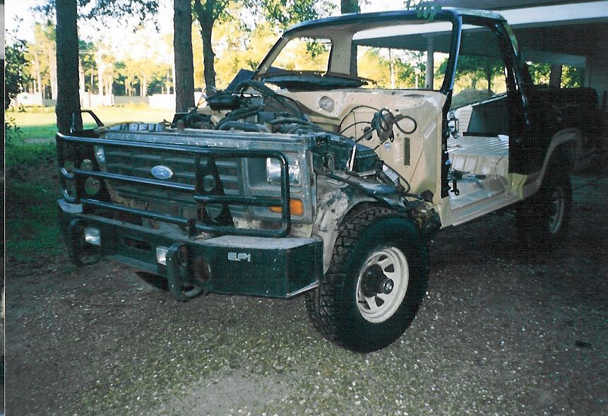 After searching the junkyards, hauling parts home, cleaning them, and then having them painted, I set the replacement body (an '82 tub) back on the chassis and started putting everything back in.

The vertical slot in the tan cowl above the tire is for the EFI EEC that goes with the engine.  It has been working fine flopping around under the hood, but now I'm putting it where it belongs, just like in '87-96 trucks.