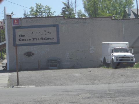 1993 Ford Bronco - A white box truck is parked next to a building with a mural of geese.