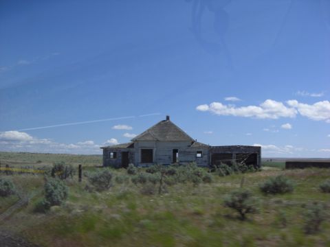 1993 Ford Bronco - Abandoned rural house and outbuilding on a clear day.