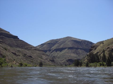 1993 Ford Bronco - A scenic view of a river winding through a mountain landscape on a sunny day.