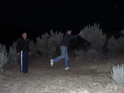 1993 Ford Bronco - Two men are in a field at night, with one appearing to be in mid-action while the other observes.