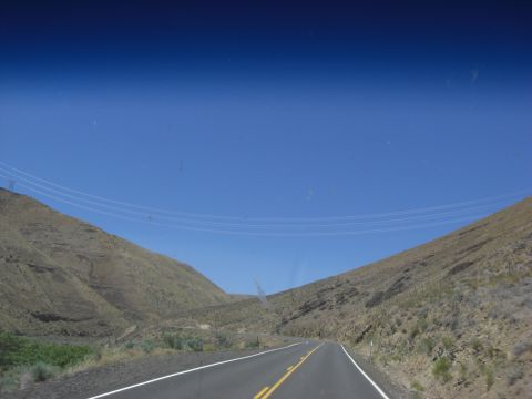 1993 Ford Bronco - View from inside a vehicle driving on a road through a canyon.