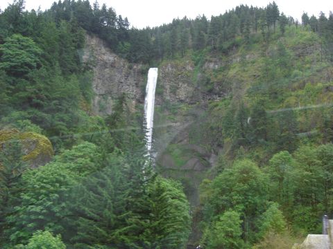 1993 Ford Bronco - A scenic view of a tall waterfall plunging down a cliff amidst a lush, green forest landscape.