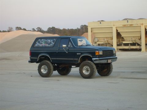 1989 Ford Bronco - This lifted Ford Bronco sits in a dusty lot, ready for off-road adventure.