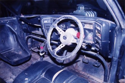 1972 Ford Ranchero - The interior of a modified vehicle features a roll cage and a prominent blower assembly on the dashboard.