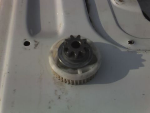 1996 Ford Bronco - A gear assembly is shown in detail, with a smaller gear meshing with a larger toothed component.