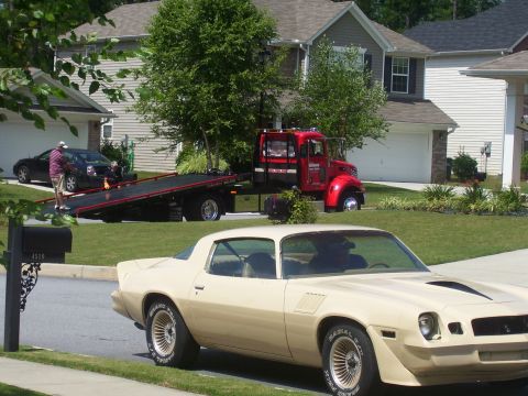 1979 Chevrolet Camaro - A tan 1979 Chevrolet Camaro is parked on the street while a tow truck is in the background.
