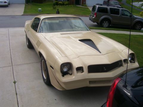1979 Chevrolet Camaro - This 1979 Chevrolet Camaro features a distinctive tan paint job and a prominent black hood scoop.