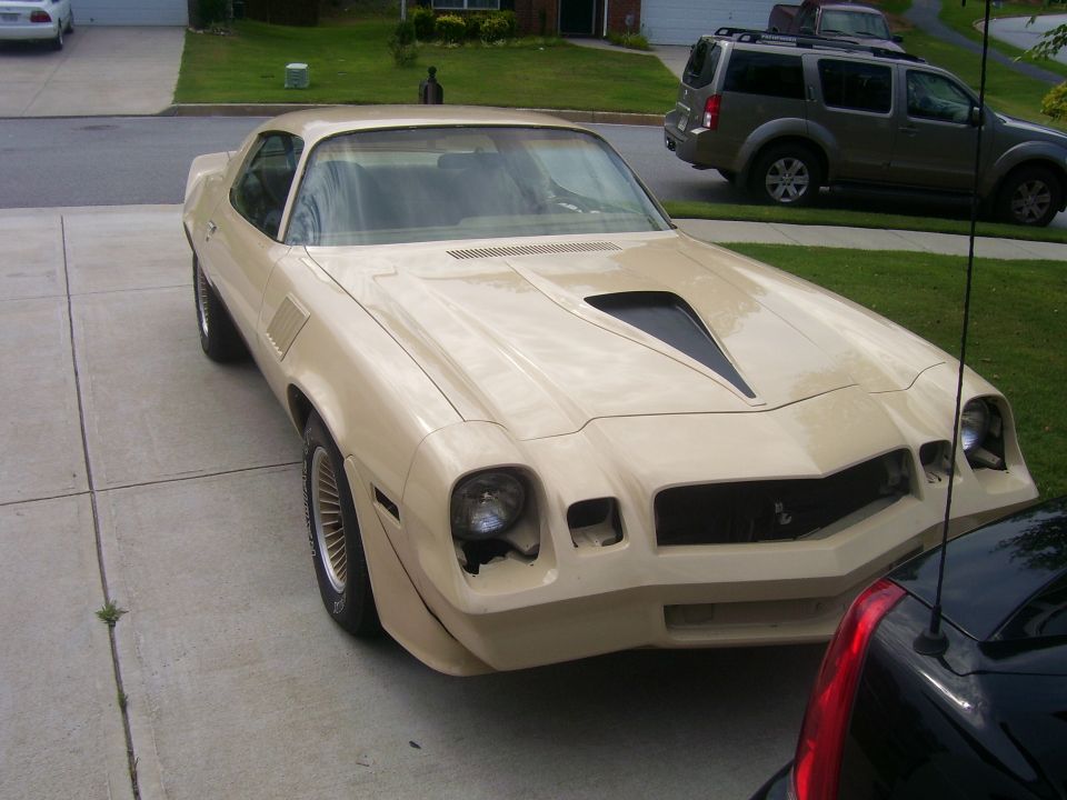 Tan 1979 Chevrolet Camaro with a black hood scoop, 3q-front view