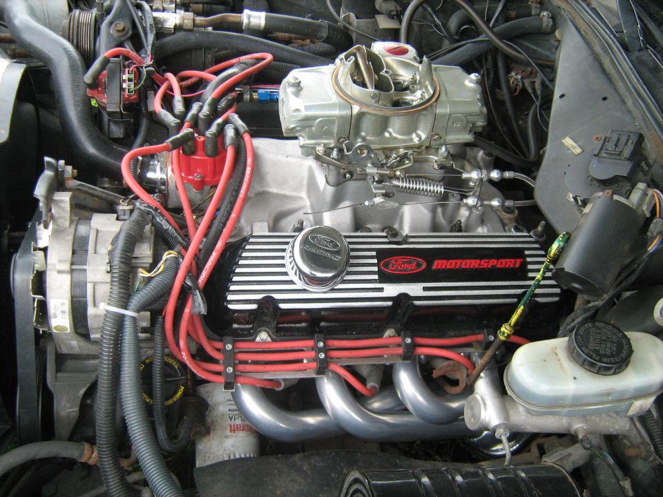 V8 engine with Ford Motorsport valve covers and carburetor in engine bay