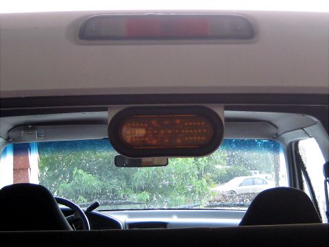 1996 Ford Bronco - An aftermarket amber light is mounted inside the vehicle, obscuring clear identification of the vehicle's make and model.