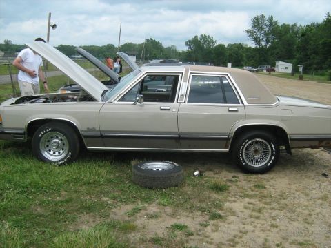 1988 Mercury Grand Marquis - 1988 Mercury Grand Marquis with hood open, parked on grass at Lapeer Dragway.