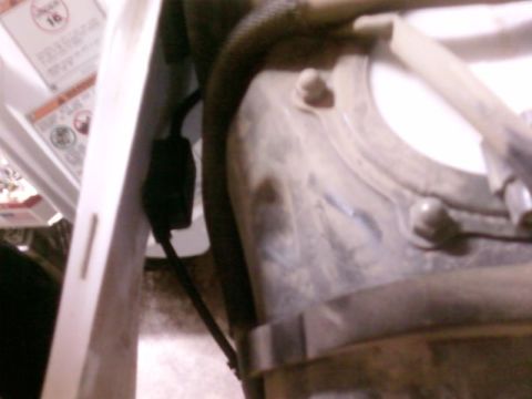 1995 Ford Bronco - Detail of a vehicle's fuel tank assembly, showing a hose and electrical connector.