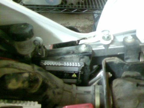 1995 Ford Bronco - A close-up view of a vehicle's electrical component, possibly a voltage regulator or similar device.