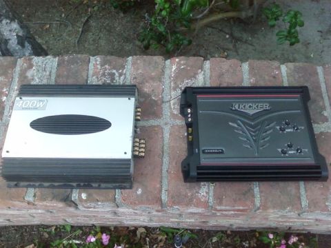 1995 Ford Bronco - Two car audio amplifiers are shown side-by-side on a brick surface.