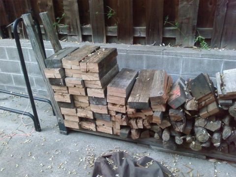 1995 Ford Bronco - A rack holds a large pile of cut firewood, ready for use.