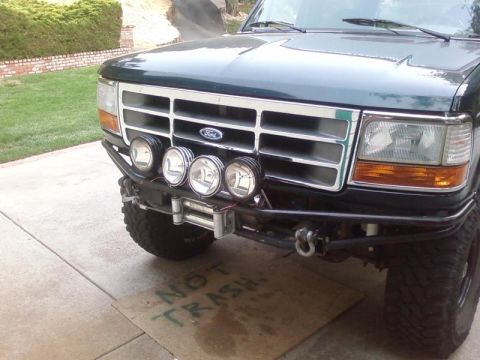 1995 Ford Bronco - Front view of a 1995 Ford Bronco a chrome grille, aftermarket bumper, and four driving lights.