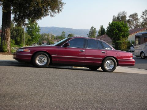 1992 Ford Crown Victoria - Maroon 1992 Ford Crown Victoria parked curbside on a sunny day.