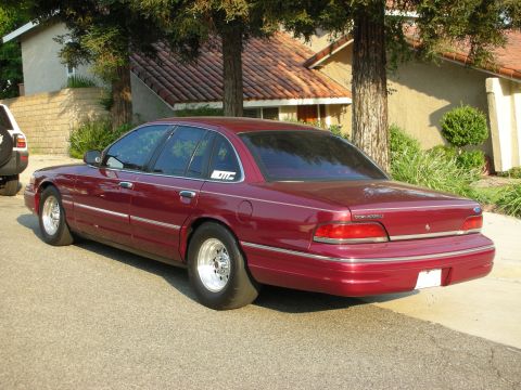 1992 Ford Crown Victoria - Rear three-quarter view of a maroon 1992 Ford Crown Victoria sedan modified with drag tires.