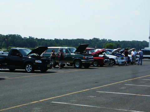 2001 Mercury Grand Marquis - A car show event displays multiple vehicles with their engines exposed for viewing.