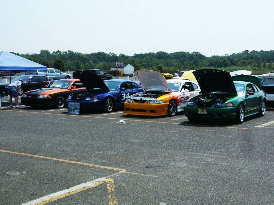 Green 2001 Ford Mustang with hood open, license plate F3519P
