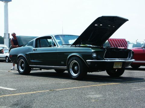 2001 Mercury Grand Marquis - Photo of a green 1968 Mustang fastback with its hood up at a car show.