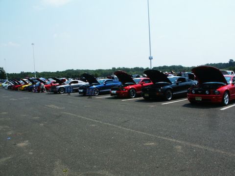 2001 Mercury Grand Marquis - Multiple vehicles are displayed with their hoods open at an outdoor car show.