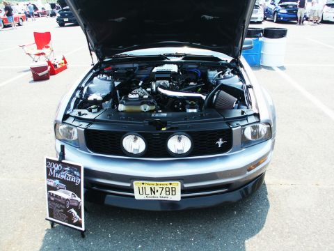 2001 Mercury Grand Marquis - Photo of a gray 2006 Mustang with its hood open and a small show placard, parked at a car show.