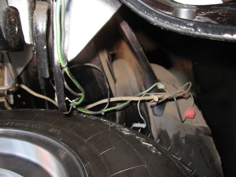 1968 Shelby GT500 - This image shows a portion of a vehicle's wiring harness and a tire, likely in the trunk or spare tire well.