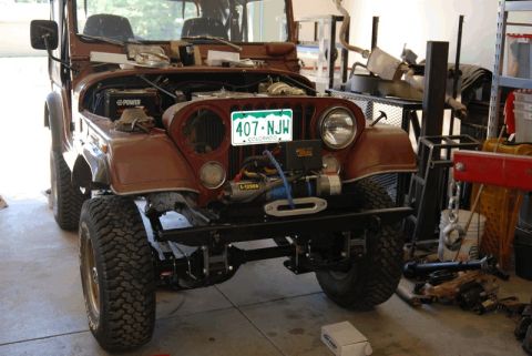 1975 Jeep CJ5 - This 1975 Jeep CJ5 is shown in a garage with its hood up and a winch mounted on the front bumper.