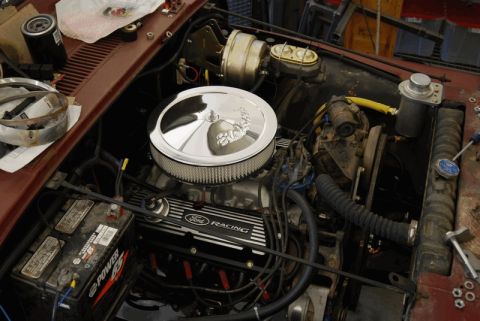 1975 Jeep CJ5 - Close-up of an engine bay Ford Racing valve covers and a chrome air cleaner assembly.