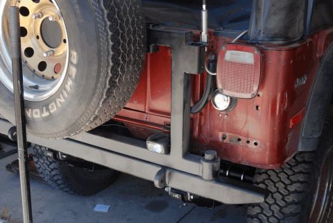 1975 Jeep CJ5 - Rear view of a 1975 Jeep CJ5, highlighting the bumper and spare tire carrier assembly.