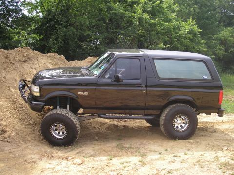 1995 Ford Bronco - This black 1995 Ford Bronco features a lifted suspension and off-road tires, ready for adventure.