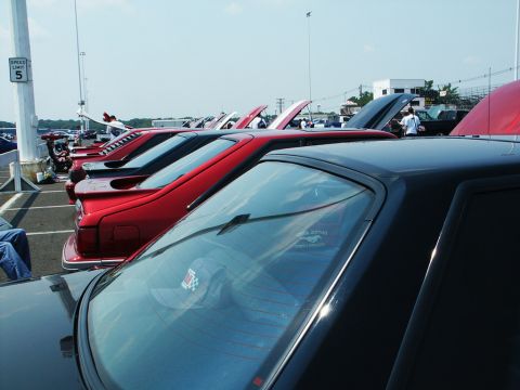 2001 Mercury Grand Marquis - Multiple cars are parked in a row at an outdoor event, with hoods open on some vehicles.