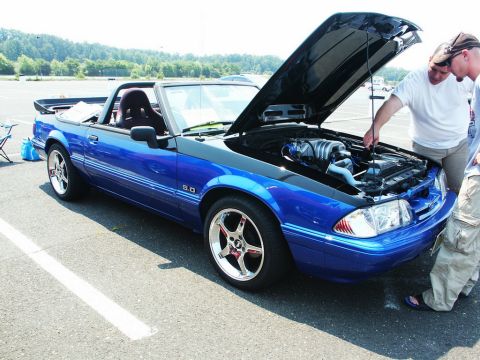 2001 Mercury Grand Marquis - Blue convertible with hood open at a car show, people looking at the engine.