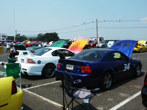 2001 Mercury Grand Marquis - Blue Ford Mustang GT with racing number 34 at a car show, other vehicles present.