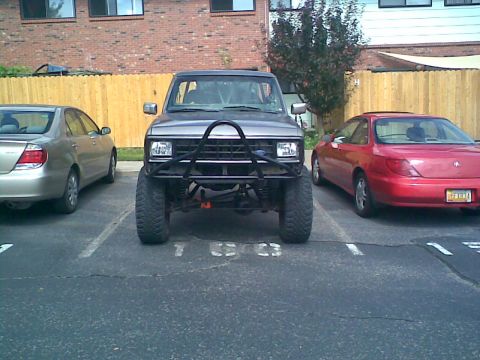 1984 Ford Bronco II - This gray SUV features a prominent brush guard and lifted suspension, consistent with a 1984 Ford Bronco II.