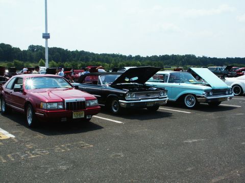 2001 Mercury Grand Marquis - A red coupe is parked at a car show with other vehicles.