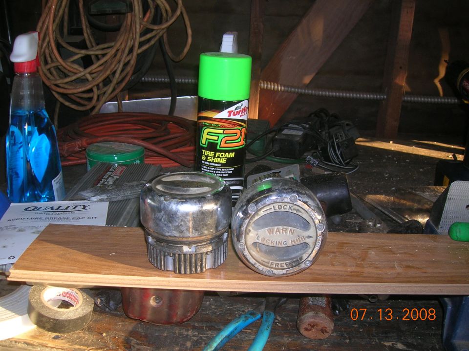Two chrome locking hubs and a can of tire foam on a shelf
