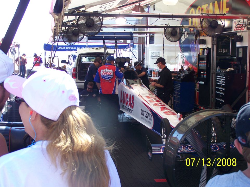 Dragster with LUCAS FUEL TREATMENT livery in a pit area with fans and people